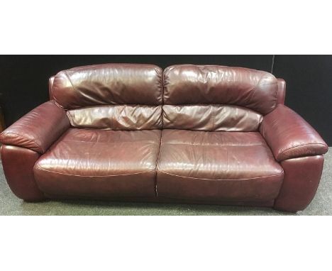 A Violino three seat sofa upholstered in oxblood leather, 85cm high x 216cm wide x 100cm deep. 