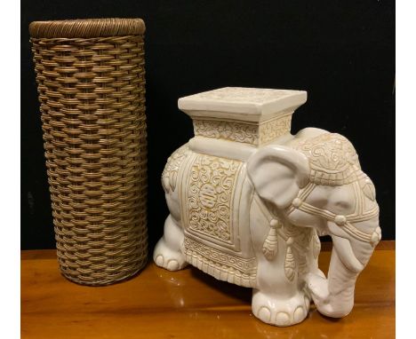 An Indian style ceramic elephant seat/plant stand; a woven wicker stick/umbrella stand 