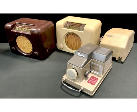 A Bakelite Bush radio type DAC90A in brown; another, cream; an Aldis 303 slide projector. (3) 