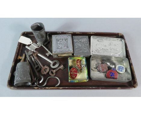 A Tray of Curios to Include Vintage Keys, Enamelled and Other Badges, Match Box Holder, Pewter Shot Glasses etc 
