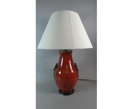 A Sang Boeuf Glazed Table Lamp with Two Applied Iron Carrying Handles, Complete with Shade, 69cm high 