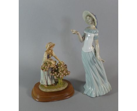 A Nao Figure of Girl with Butterfly and a Leonardo "Gathering Flowers" Figure 