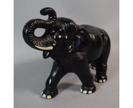 A Black Painted Ceramic Study of an Elephant with Trunk in Salute, no. 771 