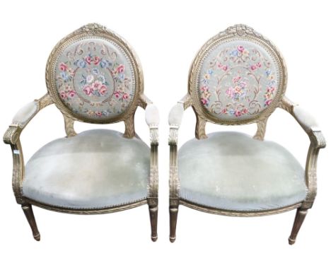 A lot comprising a pair of gilt framed tapestry upholstered parlour armchairs, 93cm high and a limed standard lamp with reede