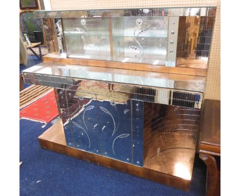 An early 20th century Art Deco mirrored drinks cabinet with glazed sliding door superstructure on base with pair of mirrored 