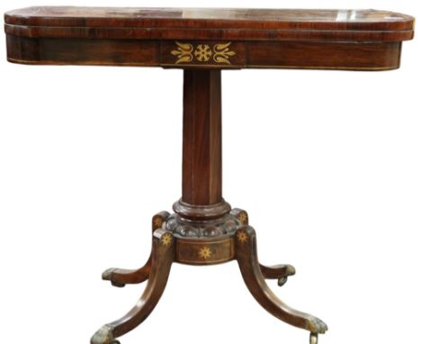 An early 20th century walnut veneered fold over card table with brass inlaid top and frieze on octagonal pedestal with brass 