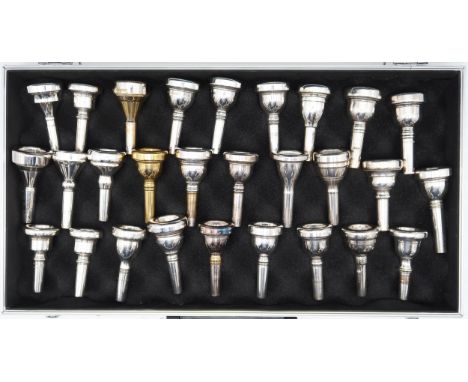 A collection of 28 various trombone mouthpieces within a padded briefcase. Names include Besson, John Packer, Kosikup, John R