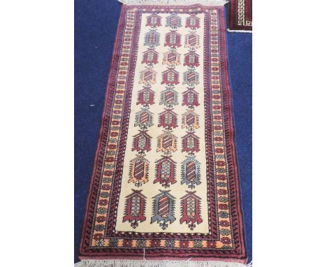 A cream ground Shrivan runner with multicoloured geometric lozenge design with floral patterned border, 190cm long x 88cm wid