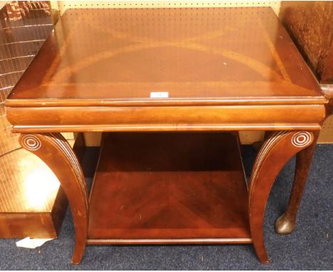 A 20th century mahogany and walnut veneered lamp table on reeded bowed supports joined by lower tier, 62cm high x 71cm wide x