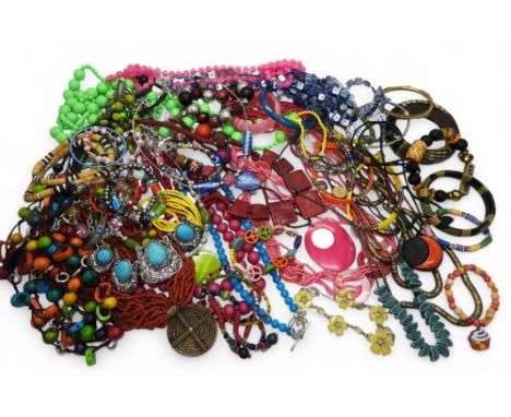 A brightly coloured collection of costume jewellery to include tribal items, statement necklaces and bangles, ceramic beads e