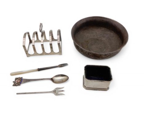 A white metal bowl inset with a 1780 thaler, a silver four division toast rack by Adie Brothers, Birmingham 1935, a silver sa