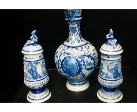 Pair of German stoneware lidded jars (finial a/f to one) together with a conforming water jug, height of jug 33cm