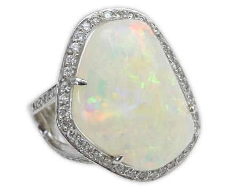 Large White Opal, Round Brilliant Cut Diamond, Blue Diamond and 18 Karat White Gold Ring. Opal with good play of multi colors