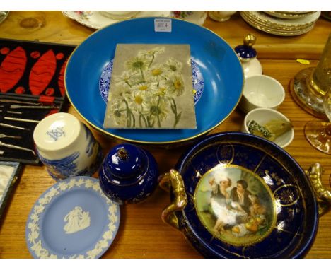 Losolware fruit bowl, a European twin handled nut dish with central decoration, an unframed glass panel of handpainted daisie