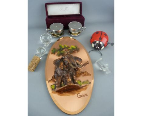A Godinger boxed Silver Treasures cruet in the form of cups and saucers, a copper effect wall ornament signed 'Gastone', a cl