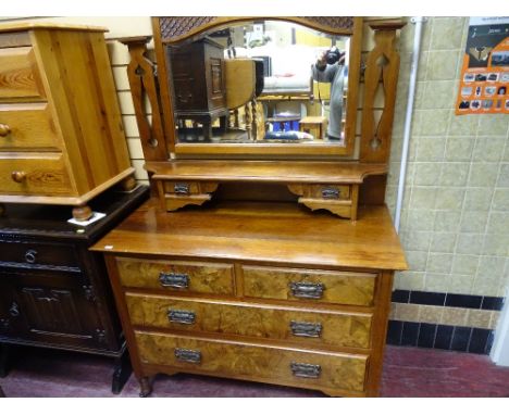 Circa 1900 walnut mirrored dressing chest having two uppers drawers with a shelf over two short and two long drawers