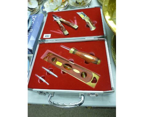Presentation set of brass and wooden hand tools in a fitted silver coloured travel case