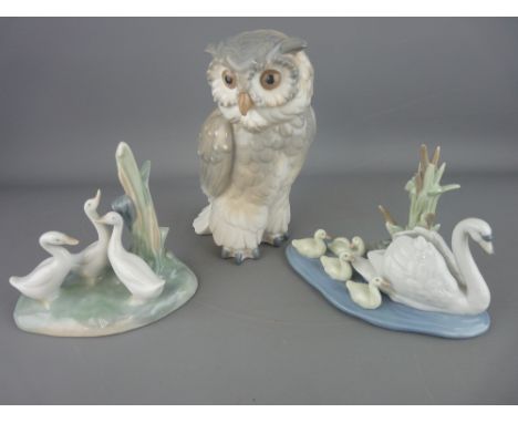 Nao porcelain model of an owl and one of three ducks and a Lladro model of a swan with cygnets 