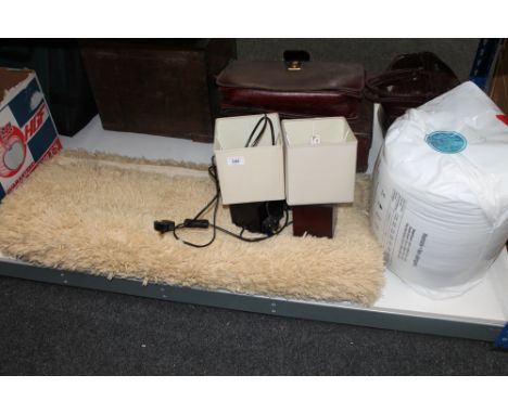 A contemporary rug together with a three way floor lamp, a pair of table lamps and a new duvet