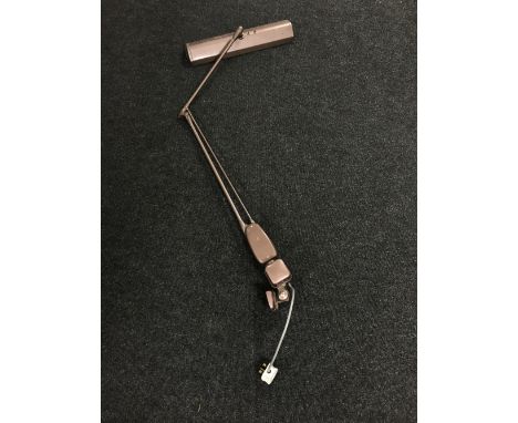An industrial metal angle poise bench light