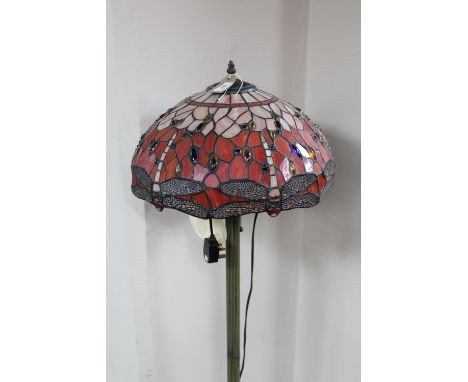 A Tiffany style standard lamp with leaded glass shade of dragon fly design