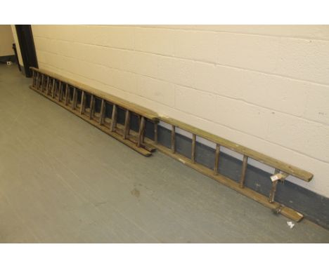 A wooden ladder together with a small wooden extension ladder 