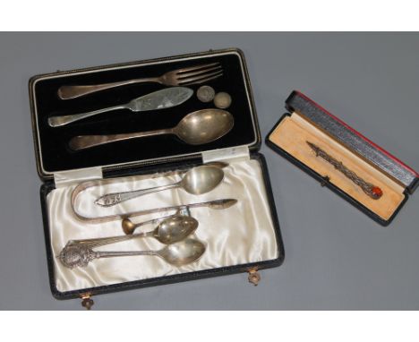 A collection of sterling silver, including a Celtic brooch, a cased baby fork and spoon, together with a set of sugar tongs, 
