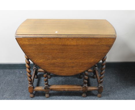 An oak barley twist gate leg table