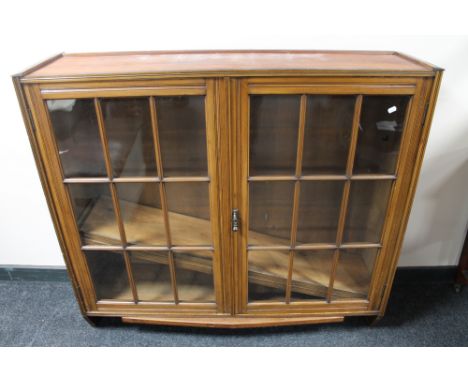 An Edwardian mahogany double door bookcase with glazed panel doors 