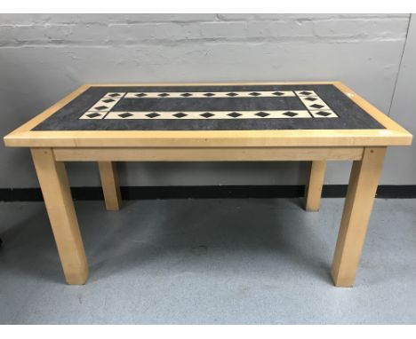 A contemporary rectangular beech table, with a tile panel insert