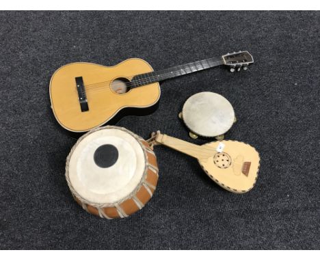 An acoustic guitar, a tambourine, a drum and a mandolin