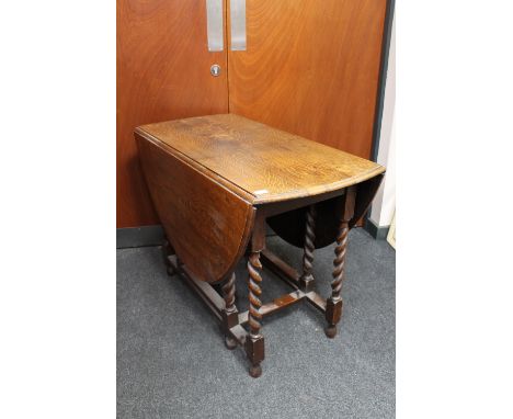 An oak barley twist gate leg table