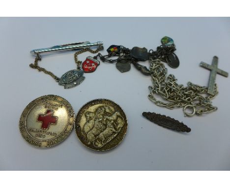 Two silver medallions including Red Cross, an enamelled charm bracelet, a silver tie pin, a silver name brooch and a chain, 6