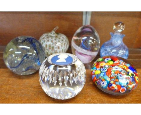 Five glass paperweights and a Caithness glass scent bottle