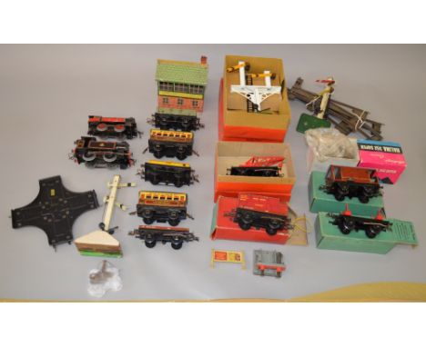 O Gauge. Hornby 0-4-0 clockwork tank engine, rolling stock including boxed items. Together with boxed semaphore signal & othe