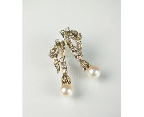 A pair of diamond and cultured pearl earrings, each designed as a stylised diamond set scroll suspending three collect set di