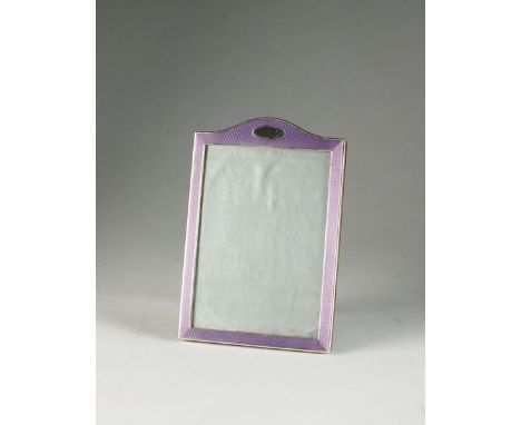 A silver and enamel mounted photograph frame, Sanders & Mackenzie, Birmingham 1927, of arched rectangular form with lilac gui