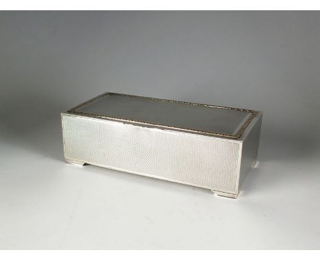 A silver mounted cigarette box, Walker & Hall, London 1927, of rectangular engine turned form with gilt metal decorative cast