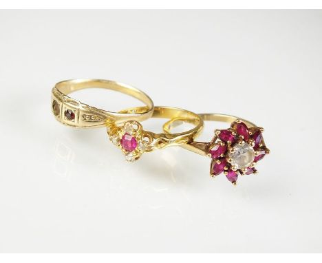 A five stone ruby and diamond cluster ring, stamped '18ct', together with a 9ct gold paste set floral cluster ring and a yell