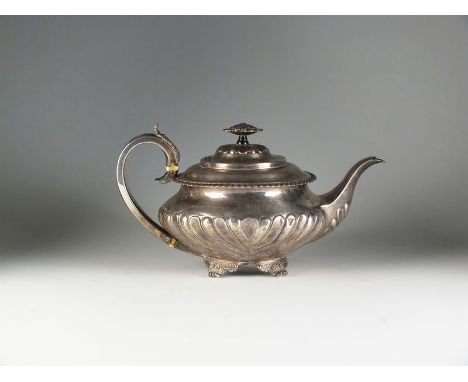 An early 19th century silver teapot, RP, London, date mark rubbed, of circular half reeded form with with engraved initials t