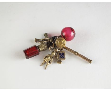 A collection of gilt charms, to include; two cranberry glass scent bottles, two miniature folding knives, a folding button ho