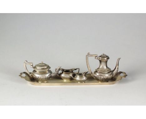 A silver miniature tea and coffee service, John Rose, Birmingham 1969, each piece of oval half reeded form, housed on elongat