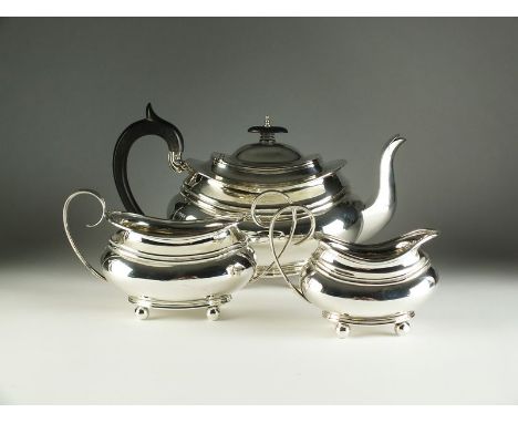 An Edwardian three piece silver tea service, Barker Brothers, Chester 1908 & 1909, each piece of boat form, comprising; a tea