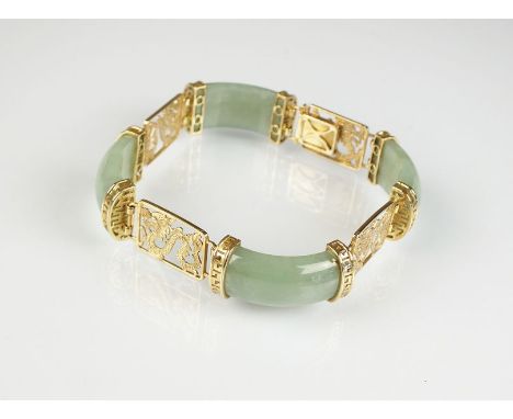 A 9ct gold jade panel bracelet, designed as four arched rectangular jade panels each interspersed with pierced 9ct gold drago