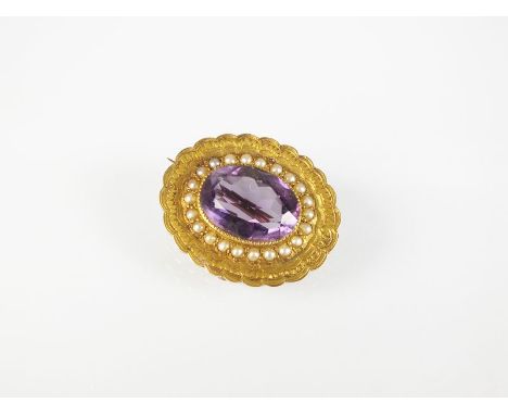 A late 19th/early 20th century amethyst and seed pearl brooch, designed as a central oval mixed cut amethyst milligrain set w