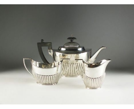 A three piece silver tea service, Mappin & Webb, Sheffield 1917 & 18, each piece of oval half reeded form, comprising; a teap