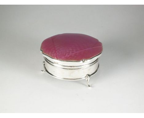A silver and enamel trinket box, Birmingham 1930, of shaped circular form with pink guilloche enamel cover, opening to reveal