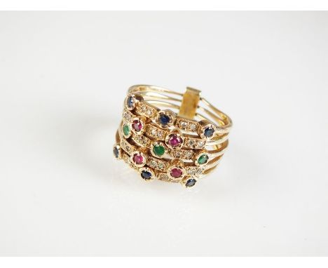 A diamond, ruby, emerald and sapphire multi-band dress ring, designed as two bands set with three sapphires and two pairs of 