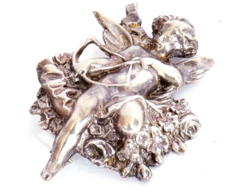 Vintage white cast metal brooch depicting Cupid and his bow and arrow resting on a garland of flowers, 5 x 4cm