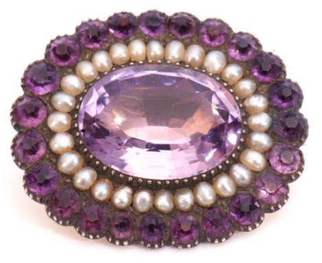 Victorian amethyst and seed pearl brooch, the large oval faceted amethyst 17mm x 12mm, within a seed pearl and further small 